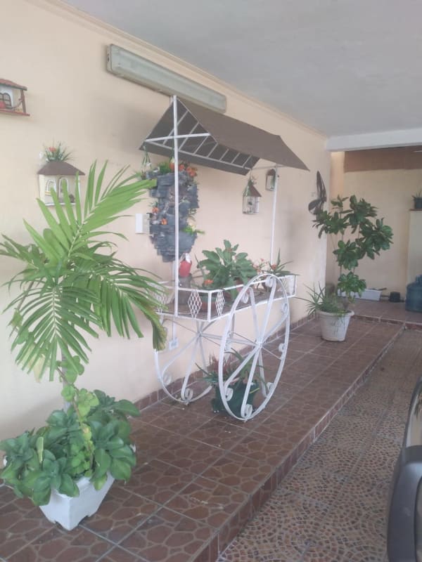 Decorated garage patio with tiled floor planters metal cart family house Altos de Panamá Panama