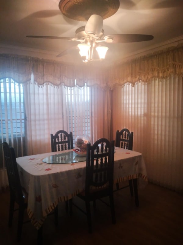 Dining area with ceiling fan, large windows, curtains in house for sale Altos de Panamá Panama City