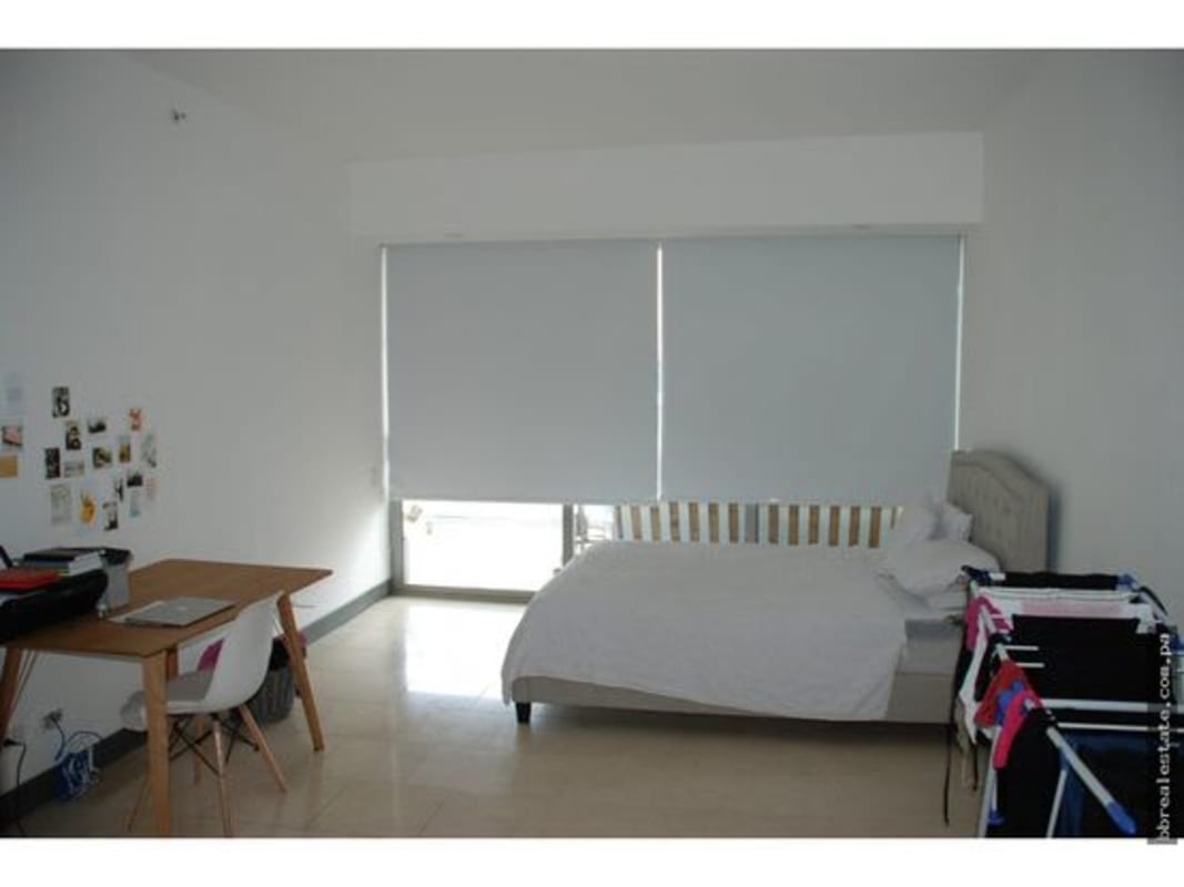 Spacious living area with floor-to-ceiling glass doors opening to ocean view balcony PH TOC Panama