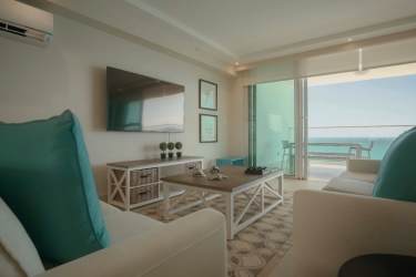 Bright guest bedroom twin beds large windows Playa Blanca Tower Panama