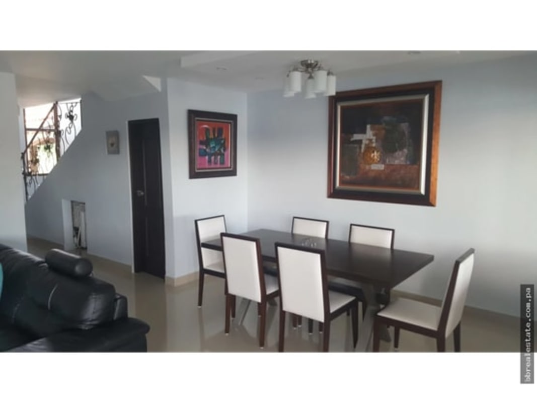 Modern dining room with six-seater table, wall art in Green Villas Las Cumbres Panama City