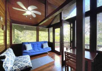 Private balcony with panoramic tropical forest views in wooden house Brisas de Los Lagos Panama