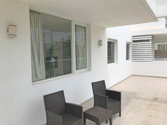 Minimalist modern open kitchen and dining area Playa Blanca Resort condo Panama