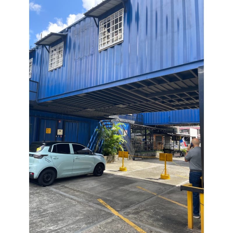 Large unfinished commercial space with concrete floors inside shipping container complex Panama