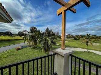 Covered balcony overlooking lush golf course and gardens at Vista Mar Beach Resort Panama