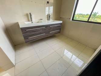 Bedroom with large window, bright natural light, tile flooring in Panama luxury villa