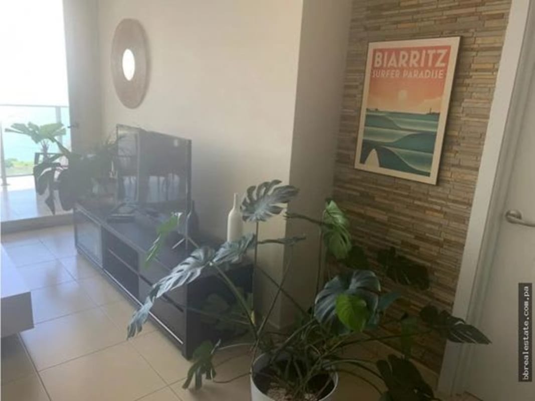 Balcony with glass railing overlooking ocean skyline and Panama City in PH White Tower Avenida Balboa