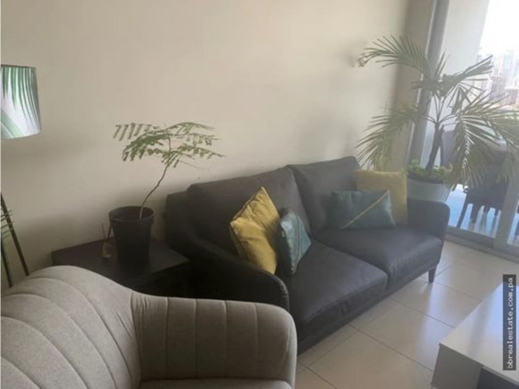 Bright living room with ocean view, sliding glass doors to balcony in PH White Tower Panama City