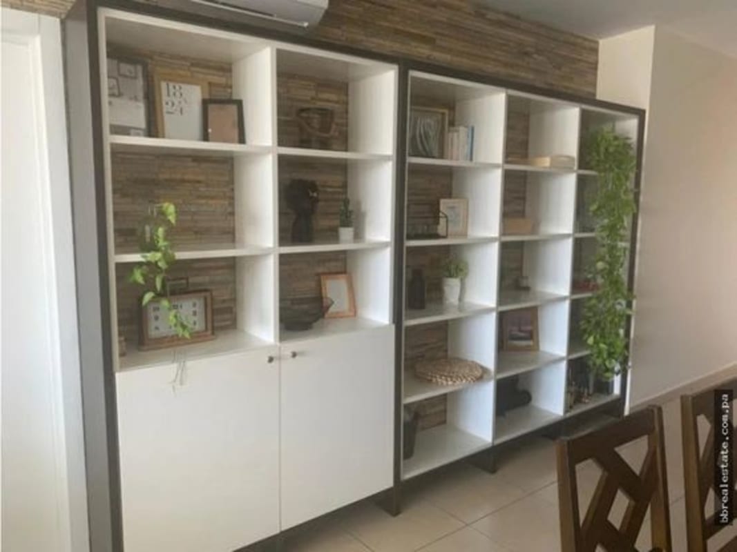 Stylish living and dining room with ocean view and indoor plants in PH White Tower Panama