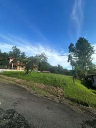 Traditional house with open green lawn and mountain backdrop at Altos del María gated community