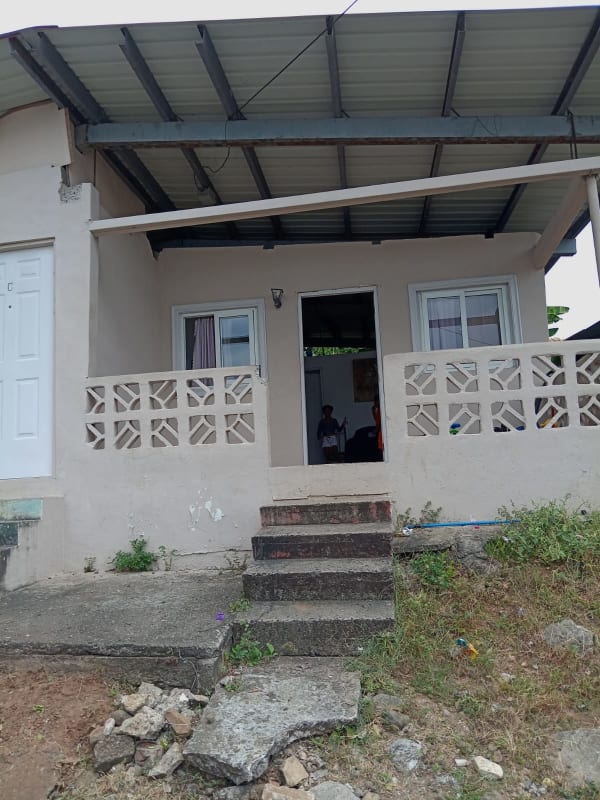 Covered porch with decorative block and concrete steps in Rio Abajo affordable home