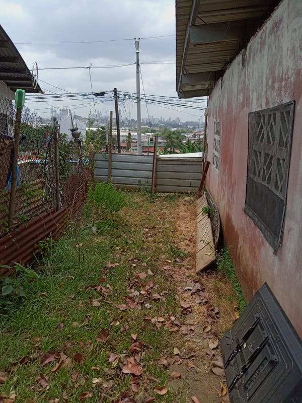 Beige concrete house with porch and metal roof for sale in Rio Abajo Panama City