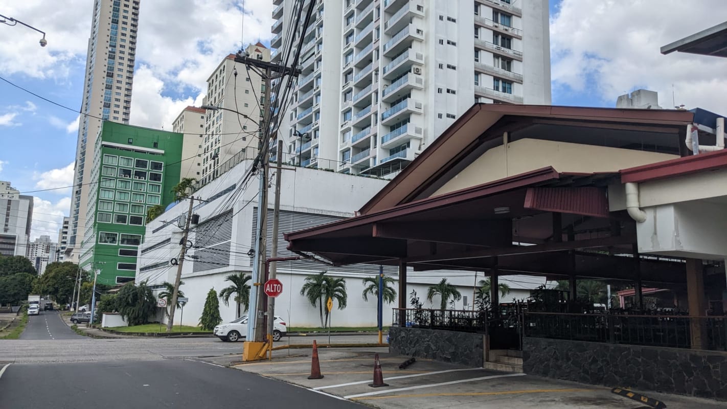 Street with parking and multi-story buildings near Coco del Mar land Panama City