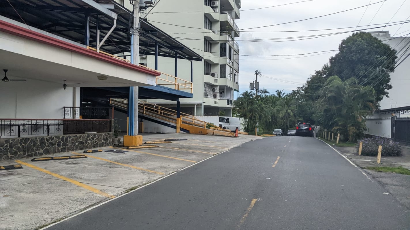 Open commercial land fenced with walls surrounded by tall buildings in Coco del Mar Panama City