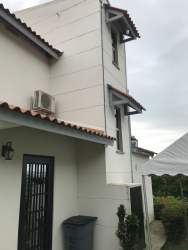 Lush side garden and front porch of country house Cabuya Chame Panama
