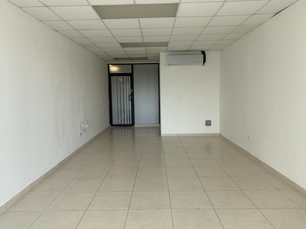 Interior empty commercial office space with ceramic tile flooring and drop ceiling in The Century Tower Panama City