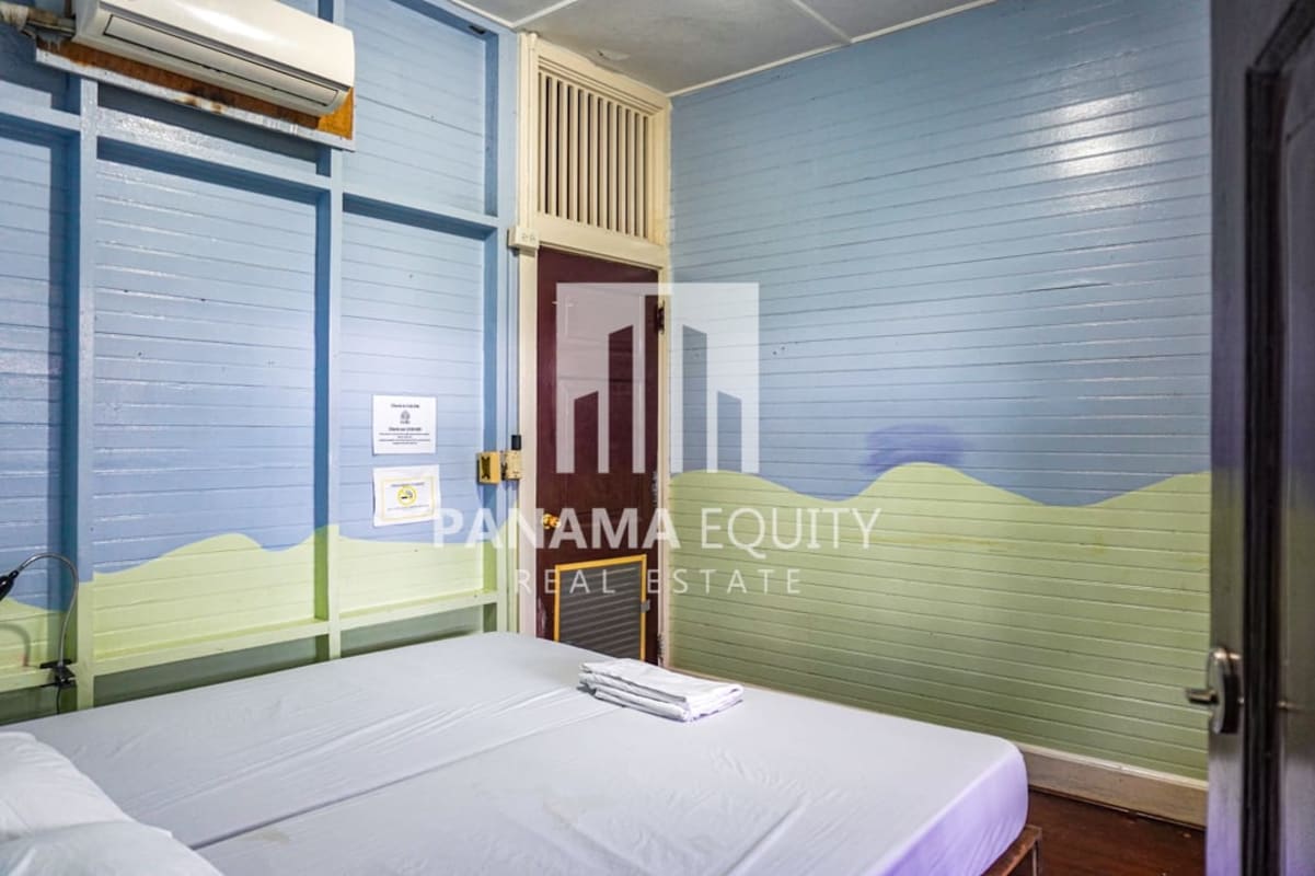 Rustic guest bedroom with pastel colors and AC in colonial Panama duplex