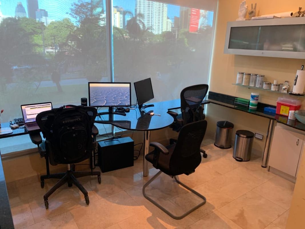 Bright office workspace with floor-to-ceiling window city skyline Punta Pacífica Panama