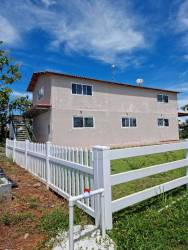 Entry driveway bordered by fencing, lush greenery, and farming landscape at Finca Granjamar Arenosa La Chorrera Panama
