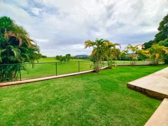 Outdoor private pool with waterfall and large terrace at luxury villa Tucan Country Club Cocolí Panama