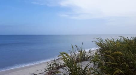 Oceanfront land with sandy beach and calm waves at Bejuco Nueva Gorgona Panama