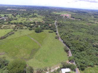 Aerial countryside shot with lagoons, green pastures, scattered trees in Coclé, Panama