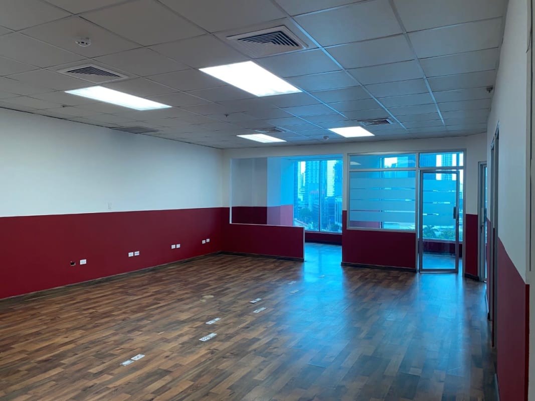 Office interior with glass partitions, wood flooring, drop ceiling at PH Marble Tower Panama