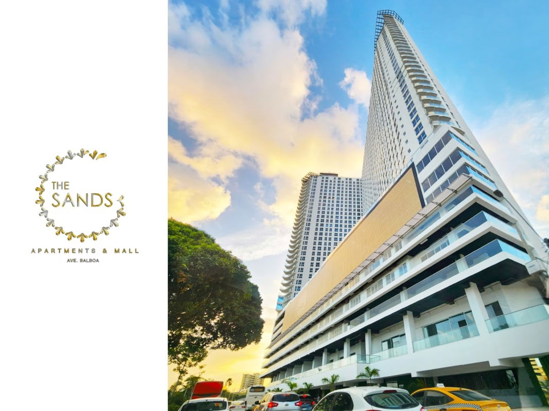 Tall modern mixed-use tower with balconies and street-level mall The Sands on Avenida Balboa Panama City