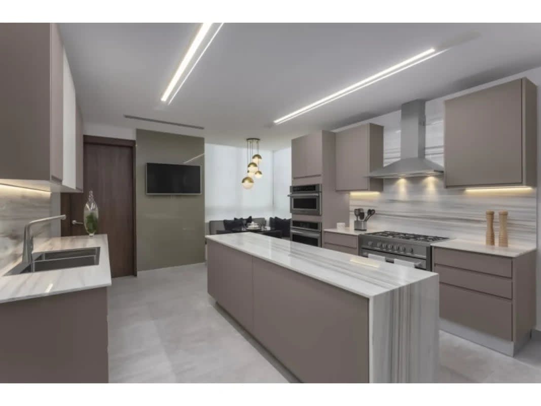 Contemporary kitchen with Silestone island, pendant lighting and marble details PH The Towers Paitilla Panama