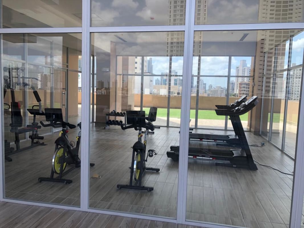 Residential gym with cardio machines skyline views PH Vicky Village Panama