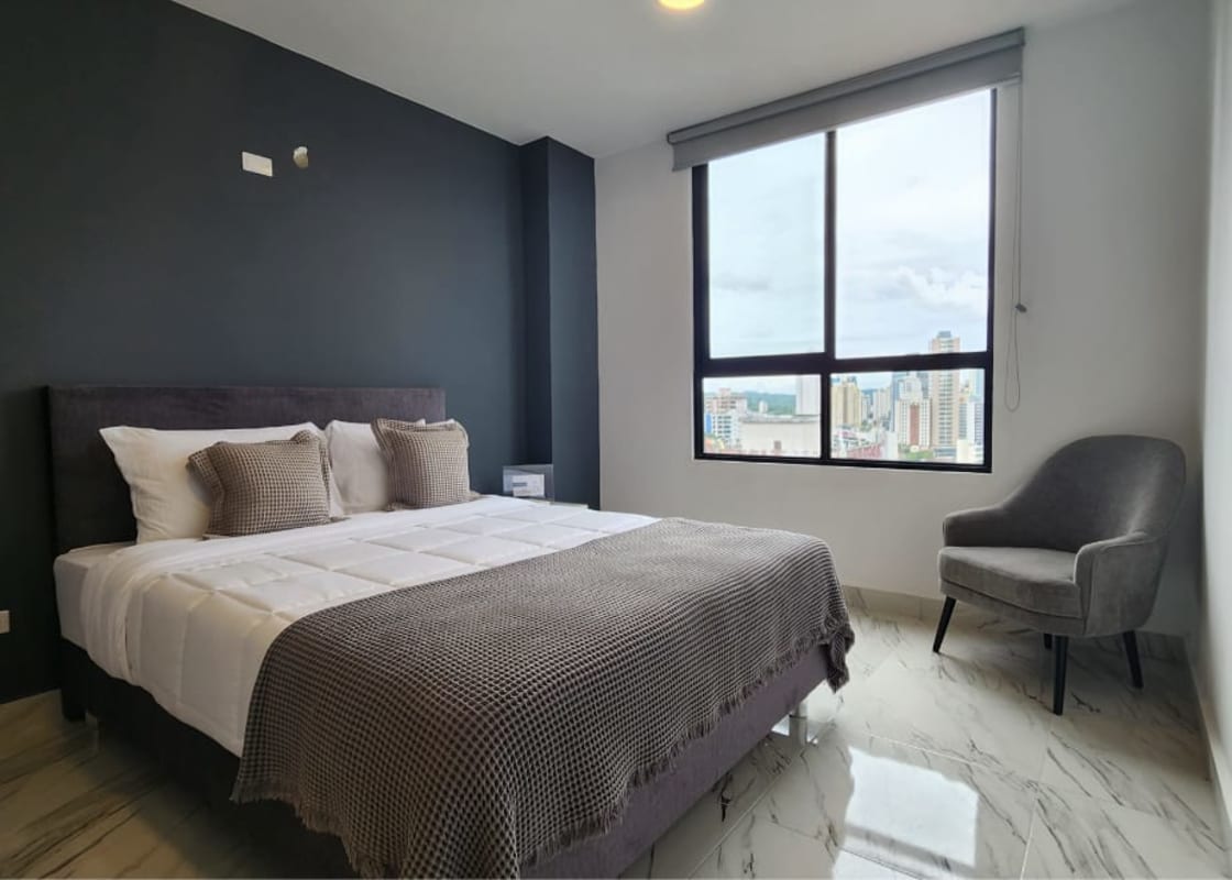Modern bedroom large window overlooking city skyline in The Gray Obarrio Panama
