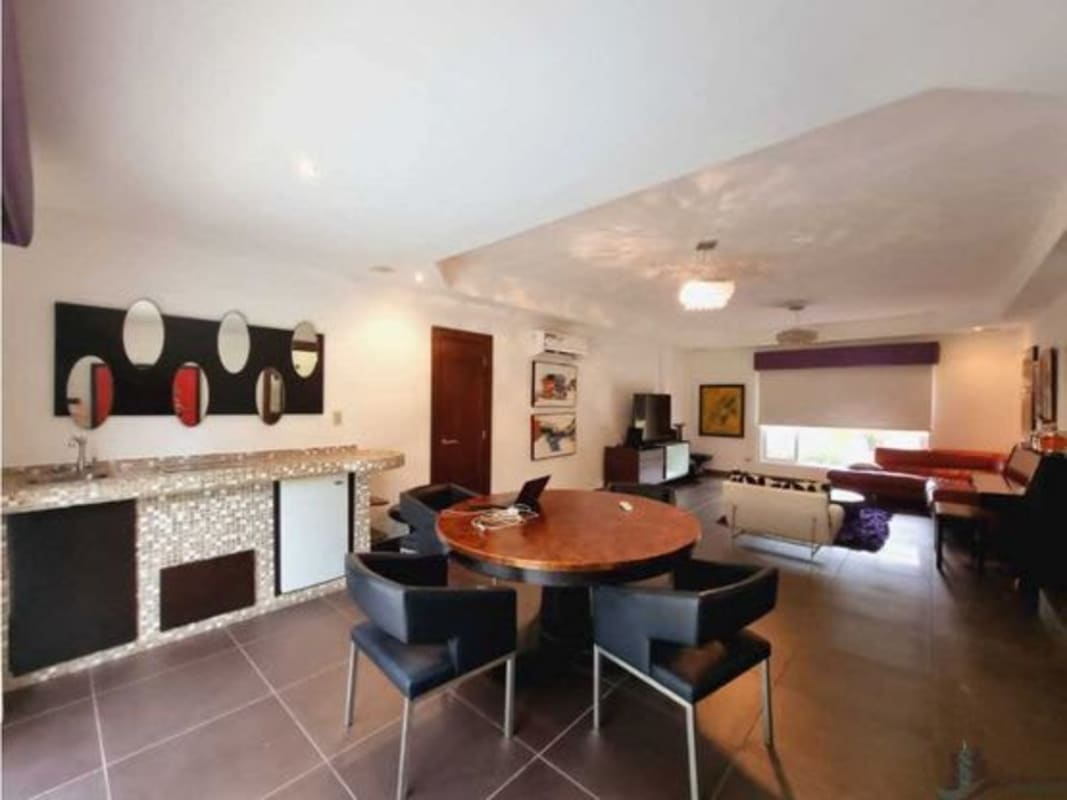 Formal dining with large windows onto lush gardens, luxury Panama home