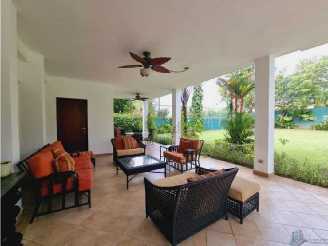 Luxury double-height living room with large windows and garden views Panama