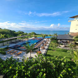 Resort pool deck with lounge chairs and ocean view at Punta Caelo San Carlos