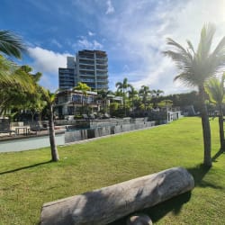 Open kitchen with island seating, pendant lights and appliances in Punta Caelo beach apartment
