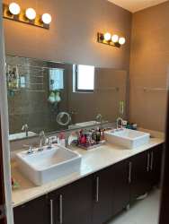Remodeled bathroom with vanity and mirror in River Valley Panama