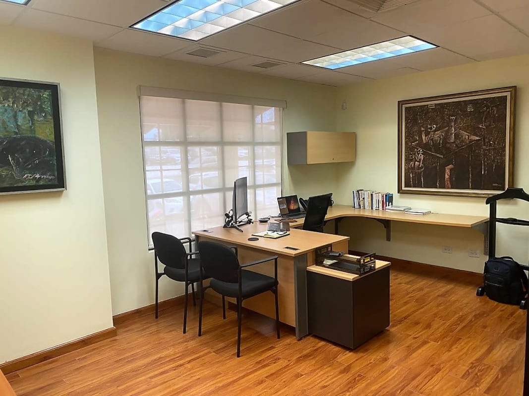 Modern private office with window, L-shaped desk, framed art San Francisco Panama