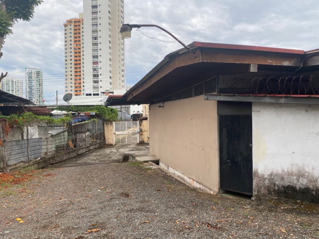 Storage shed with metal security fencing on gravel yard in Panama