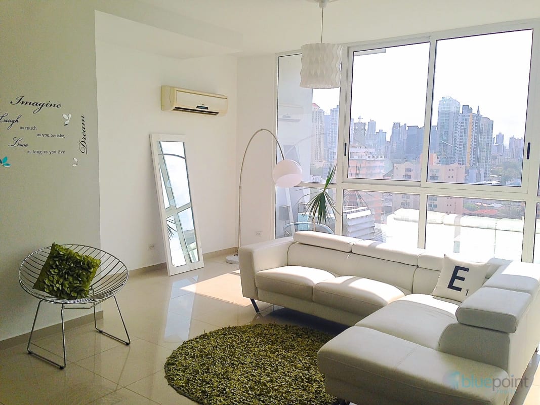 Spacious living room with large windows overlooking Parque Omar in PH Quadrat San Francisco Panama