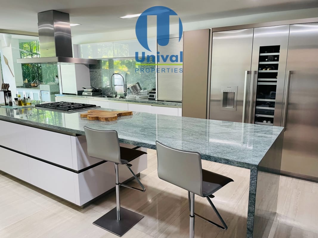 Private lush landscaped garden and covered terrace with pool in Costa Sur luxury home for sale