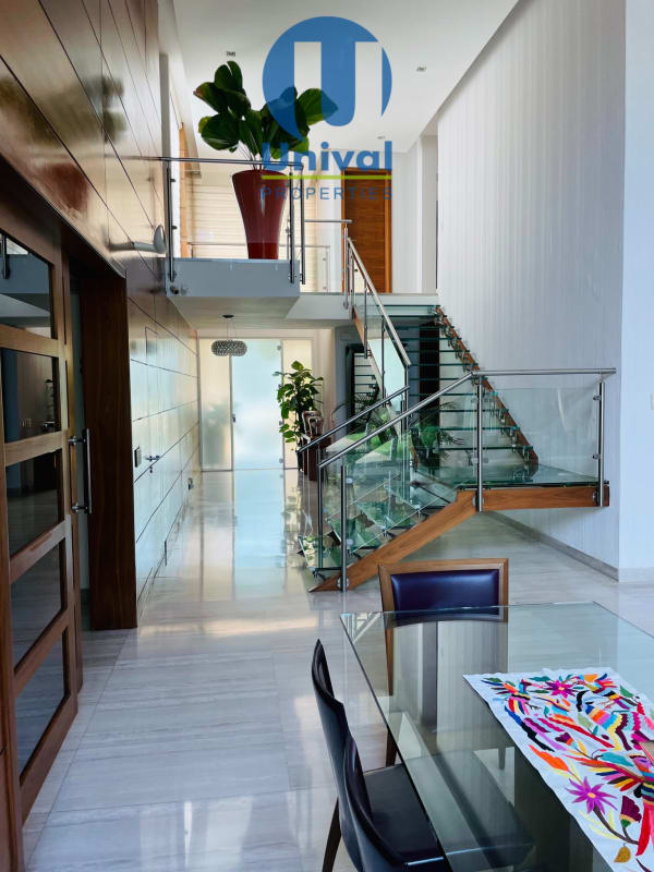 Spacious double-height living and dining room with marble floors Costa Sur Panama