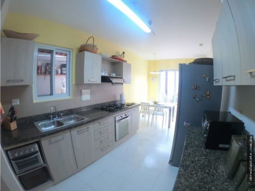 Modern kitchen featuring granite countertops, built-in appliances in Quintas de Versalles Panama