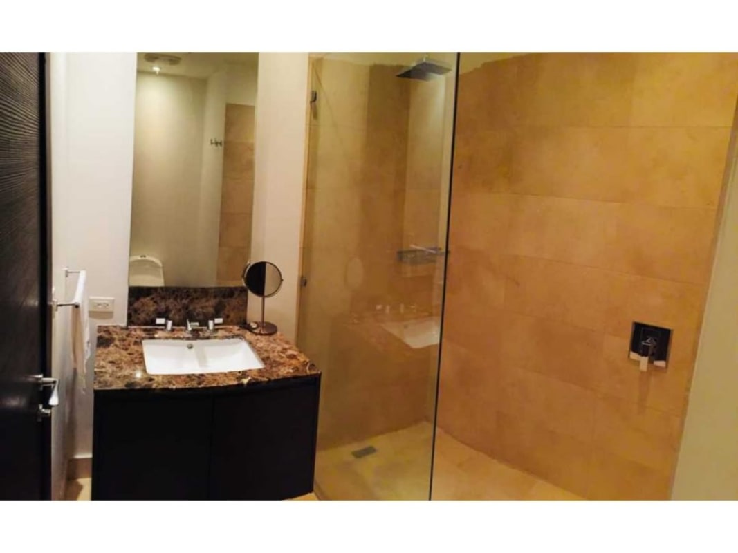 Luxury bathroom with glass shower and granite vanity in The Ocean Club JW Marriott Panama Punta Pacifica
