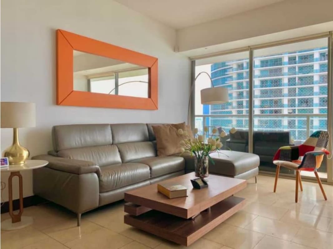 Living room with floor-to-ceiling windows, city and ocean views at The Ocean Club JW Marriott Panama City