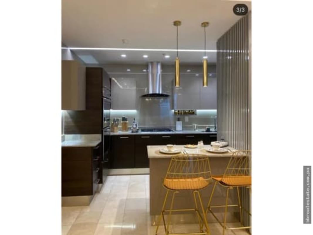 Spacious open kitchen with island breakfast bar and built-in appliances PH Grand Tower oceanfront apartment Panama