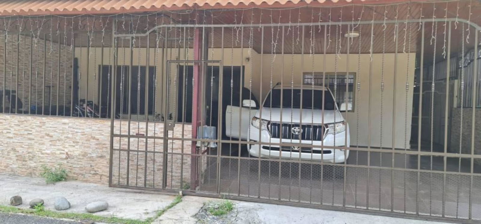 Covered parking area with metal gate in secure Paraiso Ancón Panama house