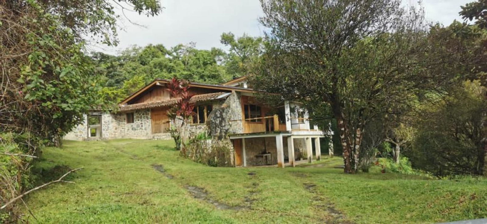 Mountain river with stone lining flowing through lush forest at Cerro Azul property for sale