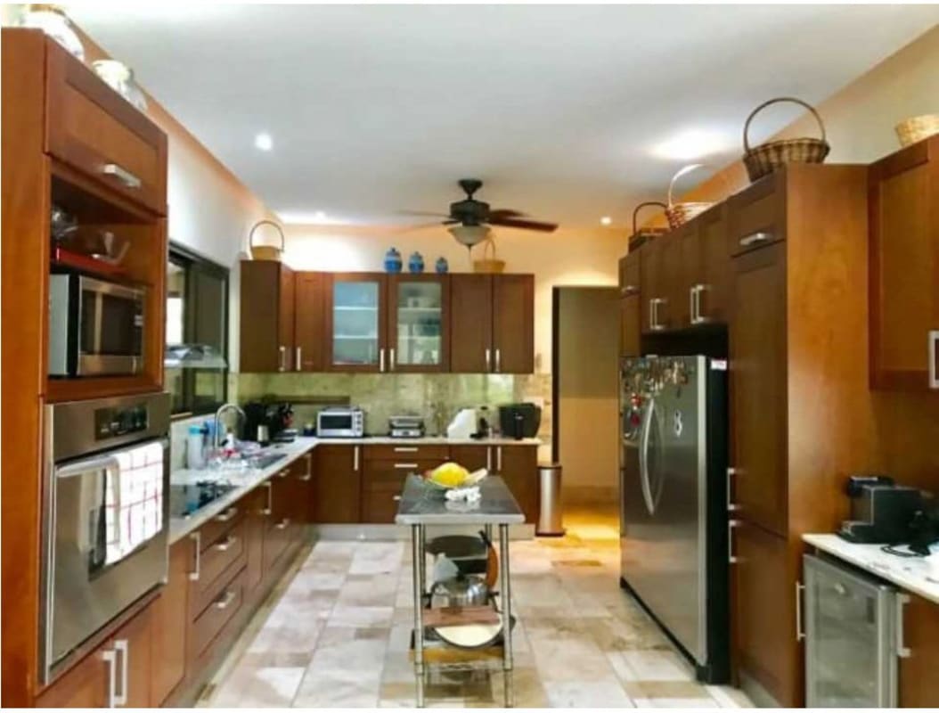 Formal dining room with large windows and marble floors at Toscana luxury home Panama City