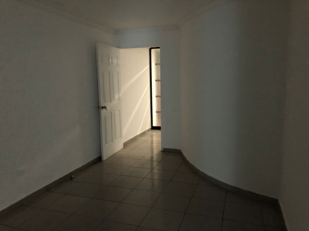 Interior hallway with white walls ceramic tiles multiple doors in Century Tower Panama