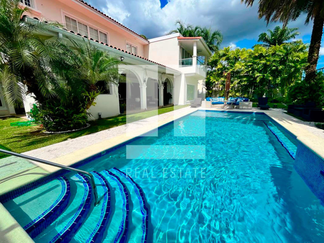 Spacious contemporary living room with marble floors, large sofas, big windows in luxury villa Royal Pacific Panama